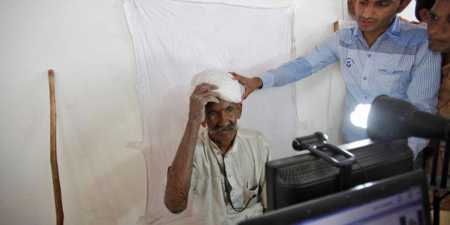 REPRESENTATIVE IMAGE: A villager gets ready to be photographed for the Unique Identification (UID) database system at an enrolment centre at Merta district in Rajasthan.