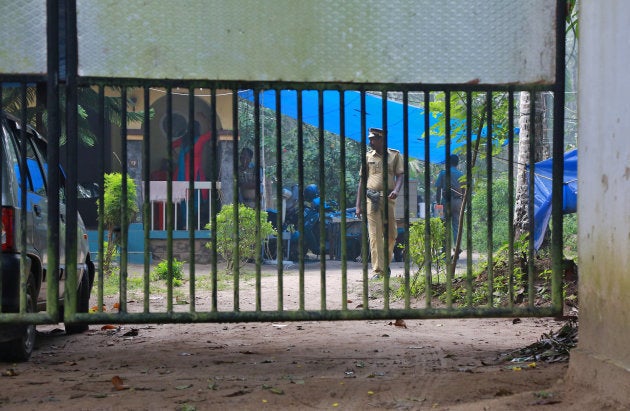 Police officers guard inside the premises of K M Ashokan, father of 24-year-old Akhila, who converted to Islam in 2016 and took a new name, Hadiya, at Vaikom in the Kottayam district.