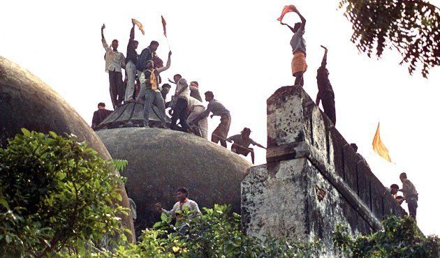 Hindu youths clamour atop the Babri Mosque five hours before the structure was completely demolished.