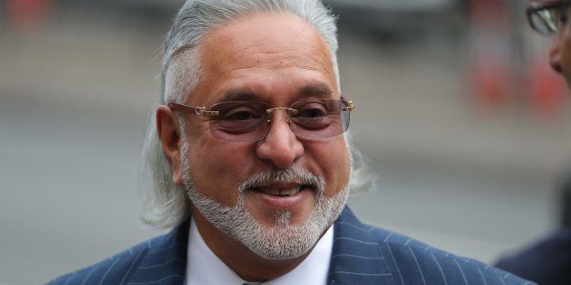 Indian tycoon Vijay Mallya reacts as he waits to re-enter Westminster Magistrates Court in central London on December 4, 2017, for the start of his extradition hearing.