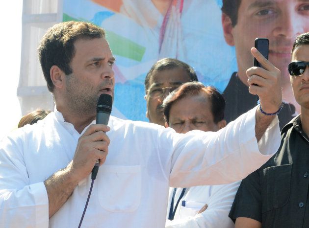 Congress Vice President Rahul Gandhi looks at his mobile phone at rally in Dahegam, some 40km from Ahmedabad, on November 25, 2017.