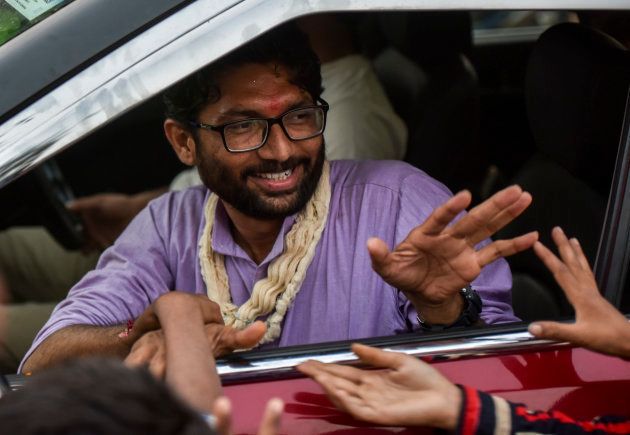Independent candidate Jignesh Mevani greets people during election campaign on December 10, 2017 in Vadgam.