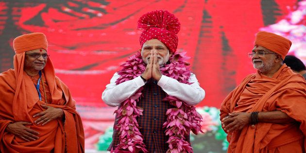 India's Prime Minister Narendra Modi greets his supporters during an election campaign meeting ahead of Gujarat state assembly elections, in Ahmedabad, India, December 3, 2017.