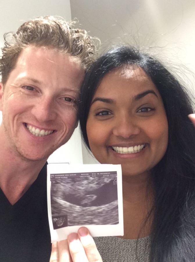 The couple with their baby's ultrasound photo.