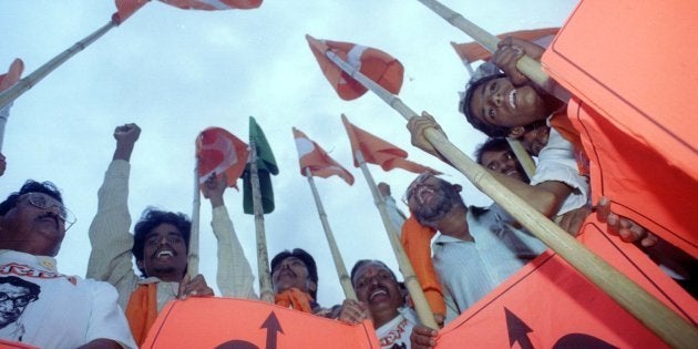 Supporters of the Shiv Sena party brandish their bow and arrow symbols at an election rally in Mumbai.