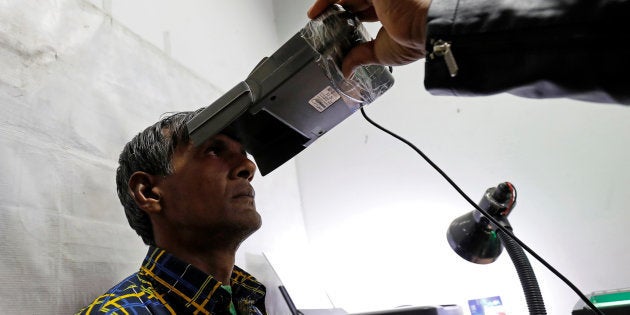 A man goes through the process of eye scanning for the Unique Identification (UID) database system, also known as Aadhaar, at a registration centre.