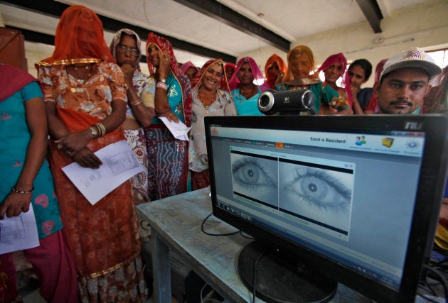 Village women stand in a queue to get themselves enrolled for the Unique Identification (UID) database system at Merta district in the desert Indian state of Rajasthan February 22, 2013.