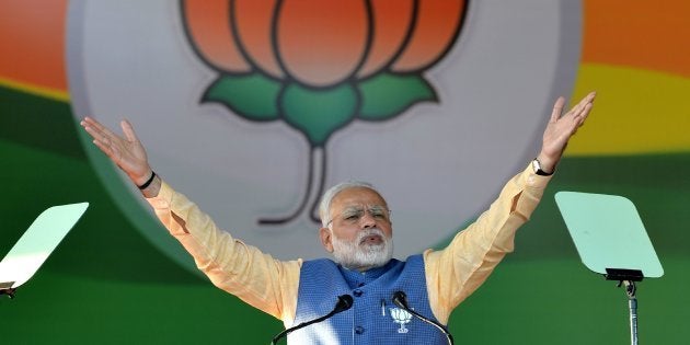 Prime Minister Narendra Modi gestures while addressing a gathering 'Parivarthana Rally' in Bangalore on February 4, 2018.