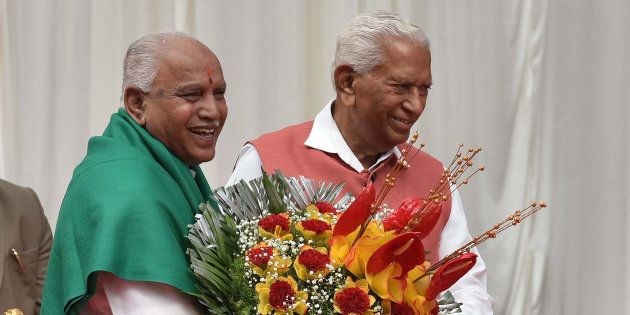 BENGALURU, INDIA - MAY 17: Governor of Karnataka Vajubhai Rudabhai Vala felicitates the Bharatiya Janata Party leader B. S. Yeddyurappa after the oath taking ceremony as the 23rd Chief Minister of Karnataka at Raj Bhawan on May 17, 2018 in Bengaluru, India. Yeddyurappa was sworn in as Karnataka?s new Chief Minister on Thursday morning after the Supreme Court refused to stay the oath-taking ceremony in a late-night hearing. (Photo by Arijit Sen/Hindustan Times via Getty Images)