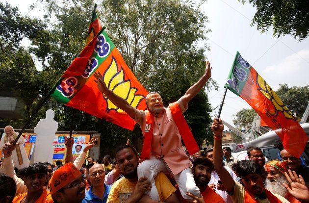 Supporters of India's ruling Bharatiya Janata Party (BJP) celebrate after learning of the initial poll results of Karnataka state assembly elections, in Bengaluru, India May 15, 2018. REUTERS/Abhishek N. Chinnappa