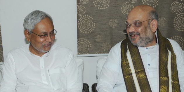 Bihar Chief Minister Nitish Kumar and BJP President Amit Shah exchange greetings at the state guest house on July 12 in Patna.