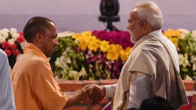 Prime Minister Narendra Modi and Uttar Pradesh Chief Minister Yogi Adityanath greet each other in Lucknow on July 29, 2018 in Lucknow.