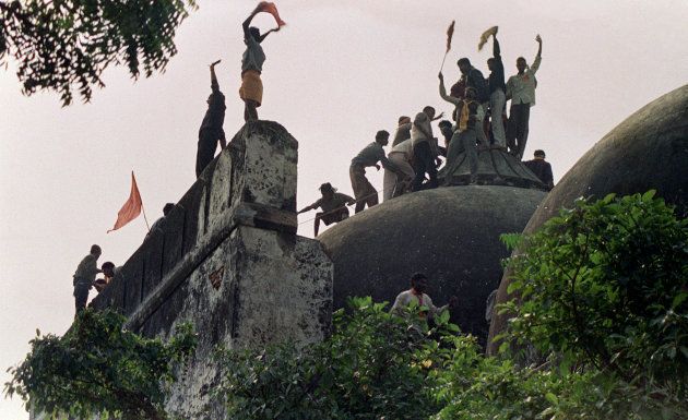 Hindu youths clamour atop the 16th century Muslim Babri Mosque in Ayodhya on December 6, 1992.