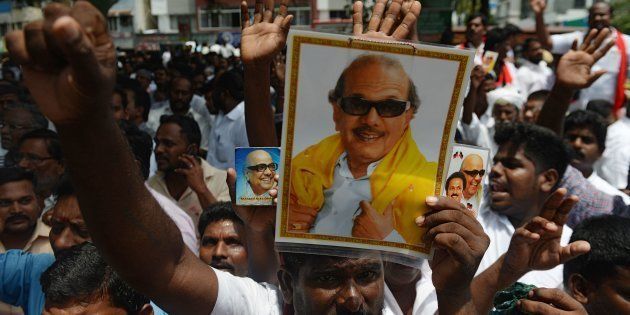 Dravida Munnetra Kazhagam (DMK) party supporters displays portraits of party president M. Karunanidhi in front of the hospital where he is being treated from a urinary tract infection, in Chennai on July 30, 2018.