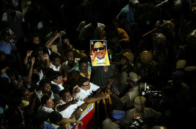 Supporters gather as an ambulance carrying the remains of Indian Tamil leader M. Karunanidhi leaves the hospital in Chennai, India August 7, 2018. REUTERS/P. Ravikumar