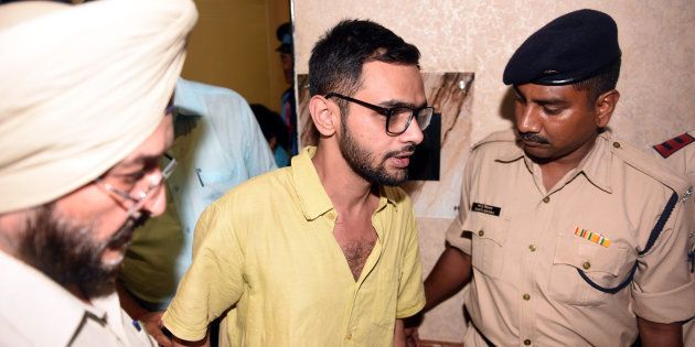 Delhi police officials with JNU student Umar Khalid who escaped unhurt after an unidentified man shot at him, outside the Constitution club at Rafi Marg on August 13, 2018 in New Delhi, India.