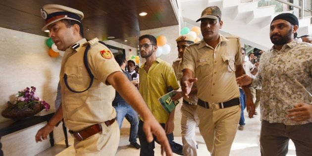 NEW DELHI, INDIA-AUGUST 13: Umar Khalid with police men at the Constitution Club in New Delhi. (Photo by K Asif/India Today Group/Getty Images)