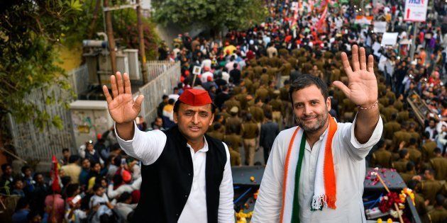 Then Congress party Vice President Rahul Gandhi (R) and Uttar Pradesh state Chief Minister Akhilesh Yadav (L) wave during a joint election rally with in Agra on February 3, 2017.