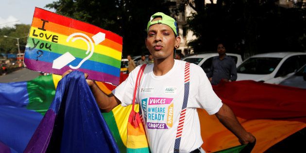 A supporter of the lesbian, gay, bisexual and transgender (LGBT) community holds a placard as he celebrates after the Supreme Court's verdict of decriminalizing gay sex and revocation of the Section 377 law, during a march in Mumbai, India, September 6, 2018. REUTERS/Francis Mascarenhas