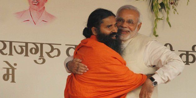 NEW DELHI, INDIA - MARCH 23: BJP prime ministerial candidate Narendra Modi and yoga guru Baba Ramdev during a 'Yoga Mahotsav' at Ramlila Maidan on March 23, 2014 in New Delhi, India.