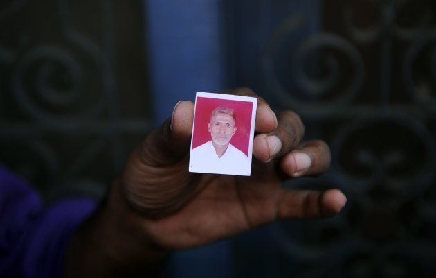 A relative holds a photograph of slain villager Mohammad Akhlaq at his home in the village of Bisada.
