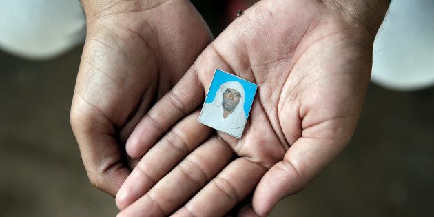 Irshad Khan, 24, holds a picture of his late father Pehlu, 55, in Jaisinghpur, India, June 2, 2017.