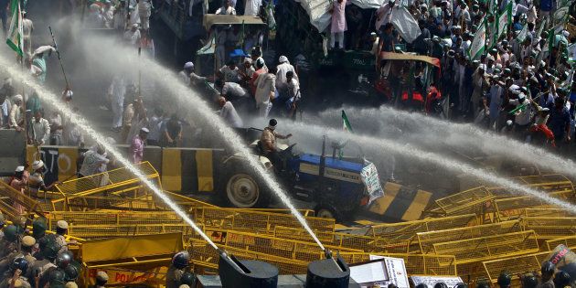 Police use water cannons to disperse farmers during a protest demanding better price for their produce on the outskirts of New Delhi, India, October 2, 2018.