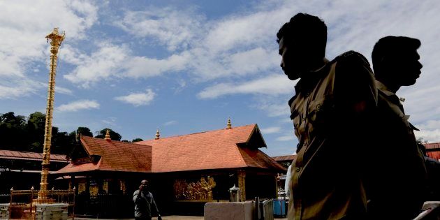 Policemen stand guard at the Sabarimala temple in Kerala this week. A local tribal community called Mala Arayas has claimed ownership of the temple.