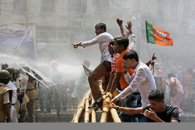 Supporters of India's ruling Bharatiya Janata Party (BJP) attempt to march towards police headquarters, as police use water cannon to disperse them during a protest in Kolkata.