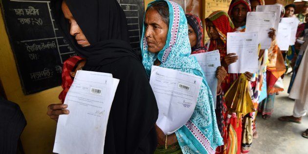Residents of Burgaon village in Morigaon, Assam, hold their documents as they stand in a queue to check their names on the final list of NRC in July.