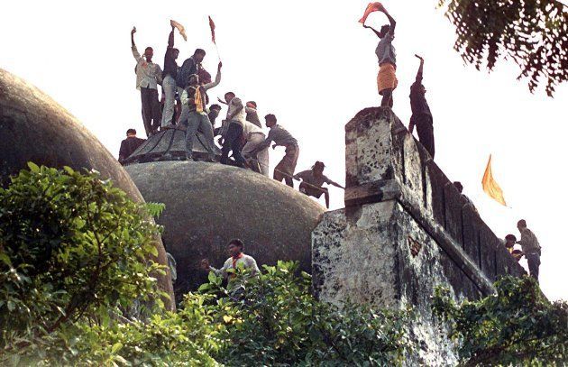 Hindu youths atop the 16th century Muslim Babri Mosque on 06 December, 1992.