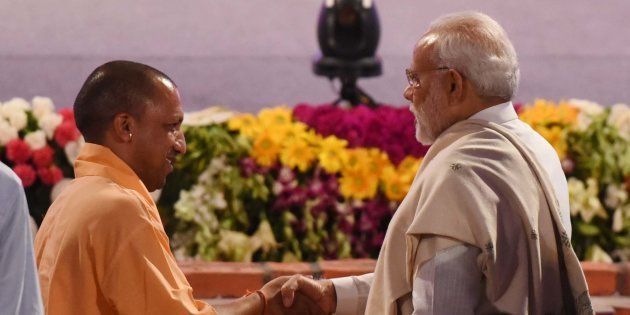 Prime Minister Narendra Modi and Uttar Pradesh Chief Minister Yogi Adityanath greets each other at an event in Lucknow in July.