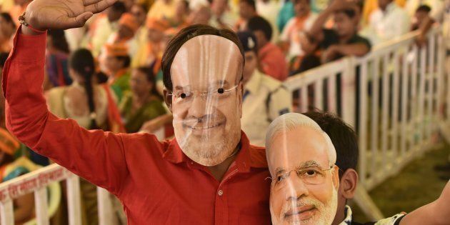 BJP workers wearing masks of party president Amit Shah and Prime Minister Narendra Modi in Bhopal.