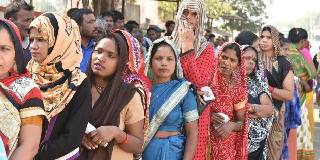 Voters stand in a queue to cast their votes in Madhya Pradesh.