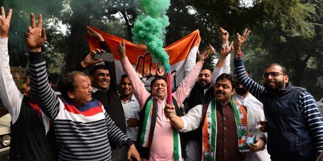 Congress supporters celebrate outside the party headquarters in New Delhi.