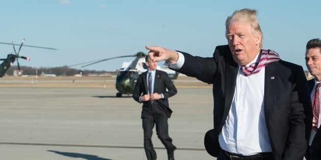 US President Donald Trump waves to wellwishers after stepping off Air Force One at Andrews Air Force Base in Maryland upon his return from Philadelphia on January 26, 2017.Donald Trump made his maiden voyage outside the Washington area as US president Thursday, meeting with lawmakers to map out their 2017 policy strategy and smooth emerging differences between the White House and congressional Republicans. / AFP / NICHOLAS KAMM (Photo credit should read NICHOLAS KAMM/AFP/Getty Images)