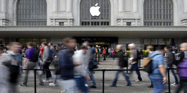 Attendees enter the Bill Graham Civic Auditorium for the Apple World Wide Developers Conference (WWDC) in San Francisco, California, U.S., on Monday, June 13, 2016. Apple Inc. has lost ground to Alphabet Inc.'s Google in the hot voice-activated assistant space. By releasing a software kit at today's Worldwide Developers Conference that lets programmers integrate Siri into their apps, it hopes to catch up with the maker of Google Now and the Android operating system -- as well as Amazon.com Inc.'s Alexa virtual helper -- and thus tie customers more closely to its iOS system. Photographer: Michael Short/Bloomberg via Getty Images