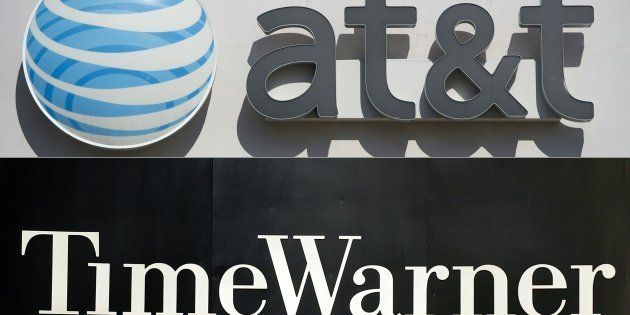 (COMBO) This combination of pictures created on October 21, 2016 shows AT&T cellphone store in Springfield, Virginia, on October 23, 2014. And the Time Warner company logo on the front of the headquarter building, 24 November, 2003, in New York. AT&T is in 'advanced talks' to acquire entertainment group Time Warner in a move to add in-house content to distribution services, The Wall Street Journal reported on October 21, 2016. AT&T could seal the deal 'as early as this weekend,' the Journal said, citing people familiar with the matter. / AFP / SAUL LOEB AND STAN HONDA (Photo credit should read SAUL LOEB,STAN HONDA/AFP/Getty Images)