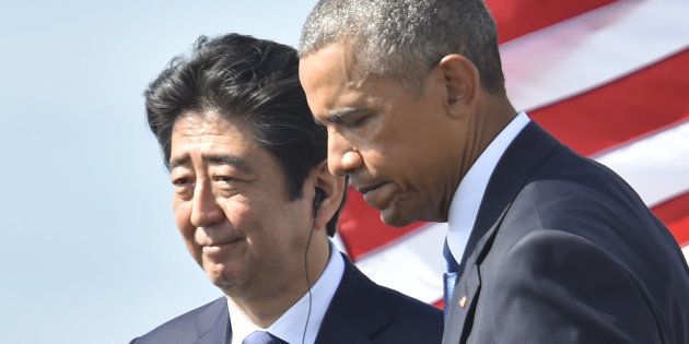 US President Barack Obama (R) walks with Japanese Prime Minister Shinzo Abe after they spoke on Kilo pier near the USS Arizona Memorial December 27, 2016 at Pearl Harbor in Honolulu, Hawaii. Abe and Obama made a joint pilgrimage to the site of the Pearl Harbor attack on Tuesday to celebrate 'the power of reconciliation. 'The Japanese attack on an unsuspecting US fleet moored at Pearl Harbor turned the Pacific into a cauldron of conflict -- more than 2,400 were killed and a reluctant America was drawn into World War II. / AFP / Nicholas Kamm (Photo credit should read NICHOLAS KAMM/AFP/Getty Images)