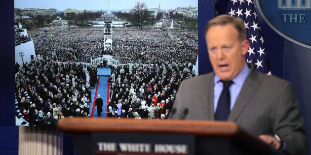Press Secretary Sean Spicer delivers a statement while television screens show pictures of U.S. President Donald Trump's inauguration at the press briefing room of the White House in Washington U.S., January 21, 2017. REUTERS/Carlos Barria