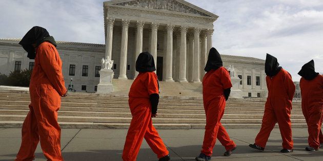 WASHINGTON, DC - JANUARY 11: Protesters gather in front of the U.S. Supreme Court to mark 15 years since the first prisoners were brought to the U.S. detention facility in Guantanamo Bay, Cuba on January 11, 2017 in Washington, DC. The protesters were asking President Obama 'to expedite releases from Guantanamo and to make public the full U.S. Senate Torture Report.' (Photo by Joe Raedle/Getty Images)
