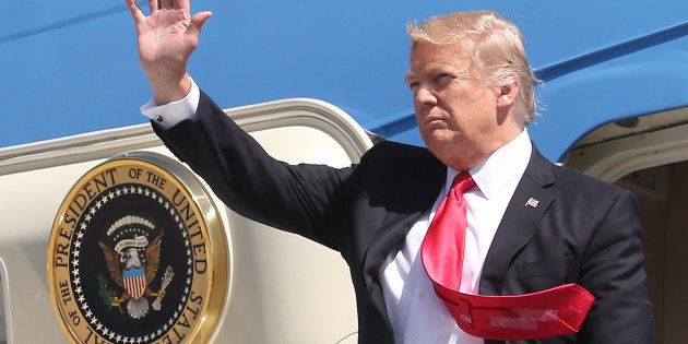A strong wind blows President Donald Trump's tie as he steps off of Air Force One at Orlando International Airport for a visit to St. Andrew Catholic School on March 3, 2017, in Orlando, Fla. (Joe Burbank/Orlando Sentinel/TNS via Getty Images)