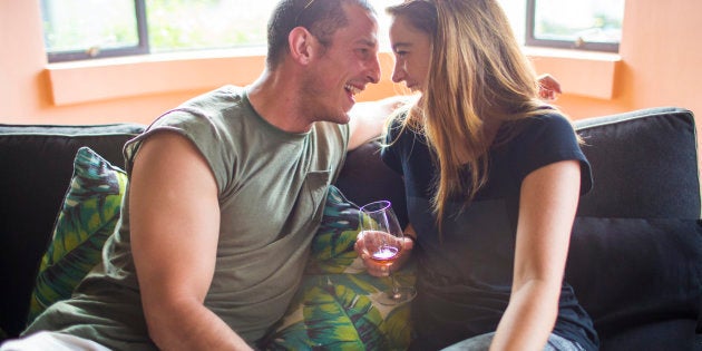 Young couple drinking laughing and having a good time