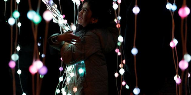 A girl plays in the ocean of lights attraction during the Diwali lights switch on in Leicester, Britain October 16, 2016.