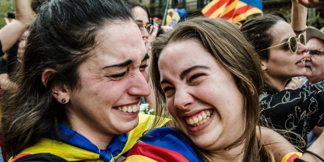 BARCELONA, CATALONIUA, SPAIN - 2017/10/27: Two pro independence supporters seen hugging each other.The public express joy and happiness following the Declaration of the Catalan Republic as they gather in front of screens which shows the live debate from the parliament. Finally, after a long morning of parliamentary debate, the pro-sovereignty majority of the Catalan Parliament wins and declares the independence of Catalonia. The constituent process of the Catalan Republic will begin. (Photo by Paco Freire/SOPA Images/LightRocket via Getty Images)