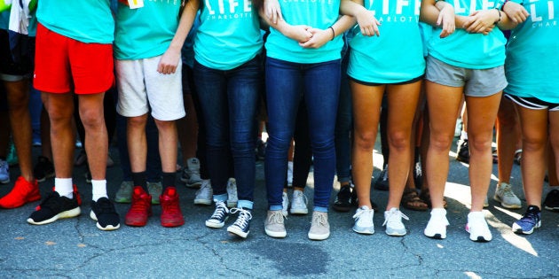 Kids link arms outside A Preferred Women's Health Center in Charlotte to protest abortion access.