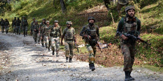 FILE PHOTO: Indian army soldiers taking positions at Hafruda forest in Kashmir's Kupwara district during a gunfight with militants on 5 October 2015.