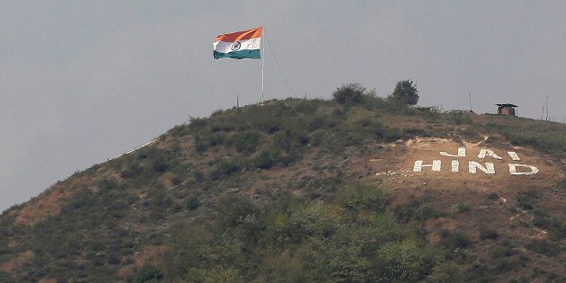 The Indian flag flies on a hill in Uri sector, near the de facto border dividing Kashmir between India and Pakistan, in Indian controlled Kashmir, Wednesday, Sept. 21, 2016. (AP Photo/Mukhtar Khan)
