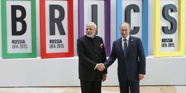 Russian President Vladimir Putin (R) greets Indian Prime Minister Narendra Modi during the welcoming ceremony at the BRICS Summit in Ufa, Russia, July 9, 2015.