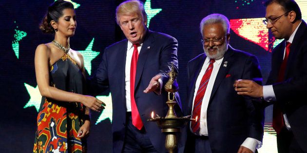 Republican presidential nominee Donald Trump (second from the left) enlists the help of Republican Hindu Coalition Chairman Shalli Kumar (second from the right) and others to light a ceremonial diya before he speaks at a Bollywood-themed charity concert put on by the Republican Hindu Coalition in Edison, New Jersey, U.S. October 15, 2016. REUTERS/Jonathan Ernst